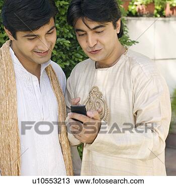 Stock Photo - close-up of a 
young man showing 
a mobile phone 
to another young 
man. fotosearch 
- search stock 
photos, pictures, 
images, and photo 
clipart