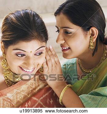 Stock Image - close-up of a 
young woman whispering 
to another young 
woman. fotosearch 
- search stock 
photos, pictures, 
images, and photo 
clipart