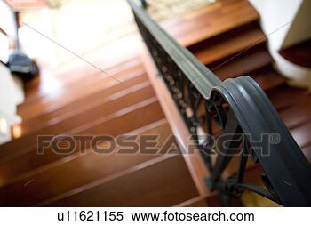 Stock Image - high perspective 
of staircase with 
wrought iron handrail. 
fotosearch - search 
stock photos, 
pictures, images, 
and photo clipart
