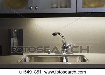 Stock Photography - kitchen faucet 
and sink. fotosearch 
- search stock 
photos, pictures, 
images, and photo 
clipart