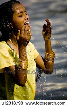 Stock Photo - young hindu girl 
playing and splashing 
the water in holy 
river. fotosearch 
- search stock 
photos, pictures, 
images, and photo 
clipart