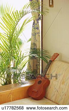 Stock Photo - guitar on sofa. 
fotosearch - search 
stock photos, 
pictures, images, 
and photo clipart