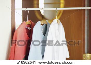 Stock Photography - t-shirts in closet. 
fotosearch - search 
stock photos, 
pictures, images, 
and photo clipart