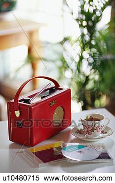 Stock Image - tea cup, radio 
and cds on table. 
fotosearch - search 
stock photos, 
pictures, images, 
and photo clipart