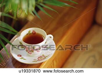 Stock Photography - tea cup on sofa. 
fotosearch - search 
stock photos, 
pictures, images, 
and photo clipart