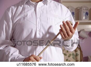 Stock Photo - man holding wooden 
spoon in a threatening 
gesture, close 
up. fotosearch 
- search stock 
photos, pictures, 
images, and photo 
clipart