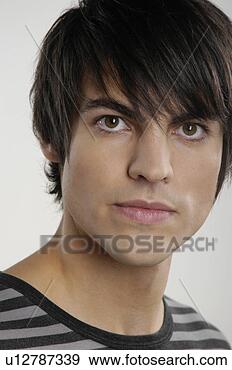 Stock Photograph - portrait of young 
man with serious 
expression. fotosearch 
- search stock 
photos, pictures, 
images, and photo 
clipart