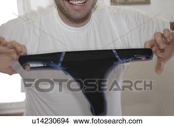 Stock Photo - young man proudly 
showing his underpants. 
fotosearch - search 
stock photos, 
pictures, images, 
and photo clipart