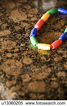 Stock Image - detail of childrens 
bracelt on a granite 
countertop. fotosearch 
- search stock 
photos, pictures, 
images, and photo 
clipart