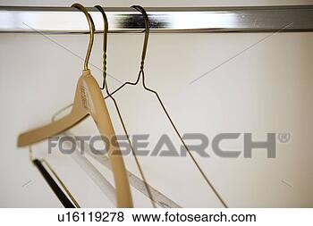 Stock Photo - detail of empty 
hangers on rod. 
fotosearch - search 
stock photos, 
pictures, images, 
and photo clipart