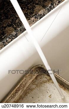 Stock Photo - detail of running 
water on a dirty 
cookie sheet. 
fotosearch - search 
stock photos, 
pictures, images, 
and photo clipart