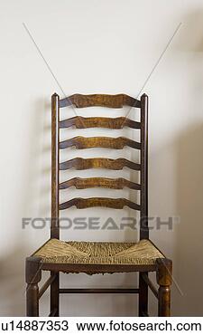 Stock Photo - detail of wood 
chair on white 
wall. fotosearch 
- search stock 
photos, pictures, 
images, and photo 
clipart