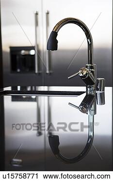 Stock Photography - modern water faucet 
with reflection. 
fotosearch - search 
stock photos, 
pictures, images, 
and photo clipart