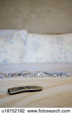 Stock Photo - television remote 
resting on bed 
spread. fotosearch 
- search stock 
photos, pictures, 
images, and photo 
clipart