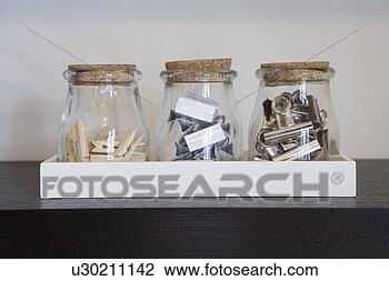 Stock Photo - three jars with 
clothes pins and 
metal clips. fotosearch 
- search stock 
photos, pictures, 
images, and photo 
clipart