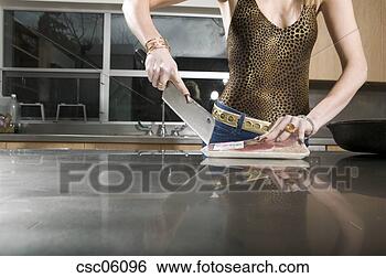 Stock Photo - glamorous woman 
cutting meat with 
a knife. fotosearch 
- search stock 
photos, pictures, 
images, and photo 
clipart
