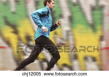 Stock Image - man running past 
wall of graffiti. 
fotosearch - search 
stock photos, 
pictures, images, 
and photo clipart