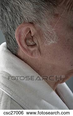 Stock Photo - senior man wearing 
hearing aid. fotosearch 
- search stock 
photos, pictures, 
images, and photo 
clipart