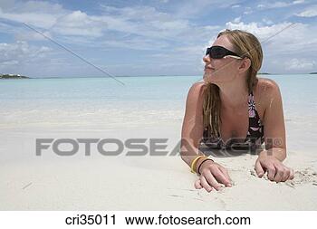 Stock Photography - young woman relaxing 
on beach, bahamas, 
nassau island, 
caribbean. fotosearch 
- search stock 
photos, pictures, 
images, and photo 
clipart