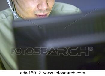 Stock Photo - asian businessman 
using headset 
while working. 
fotosearch - search 
stock photos, 
pictures, images, 
and photo clipart
