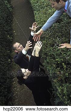 Stock Photo - businessman and 
businesswoman 
reaching help 
over a hedge. 
fotosearch - search 
stock photos, 
pictures, images, 
and photo clipart