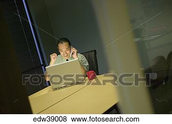 Stock Photo - businessman celebrating 
at laptop. fotosearch 
- search stock 
photos, pictures, 
images, and photo 
clipart