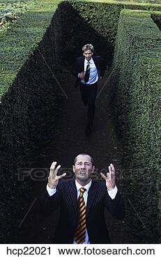 Stock Photography - businessman chasing 
another in hedge 
maze. fotosearch 
- search stock 
photos, pictures, 
images, and photo 
clipart