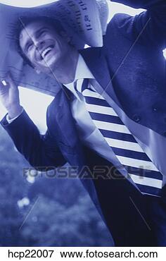 Picture - businessman protecting 
himself from rain 
with newspaper. 
fotosearch - search 
stock photos, 
pictures, images, 
and photo clipart