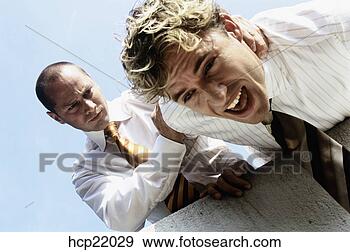 Stock Photograph - businessman pushing 
co-worker over 
ledge. fotosearch 
- search stock 
photos, pictures, 
images, and photo 
clipart