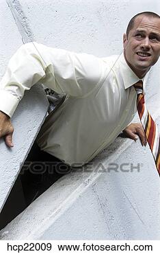 Stock Photograph - businessman stuck 
in wall crevice. 
fotosearch - search 
stock photos, 
pictures, images, 
and photo clipart