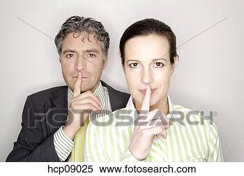 Stock Image - businesspeople 
making quiet sign. 
fotosearch - search 
stock photos, 
pictures, images, 
and photo clipart