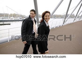 Stock Photography - businesspeople 
walking and talking. 
fotosearch - search 
stock photos, 
pictures, images, 
and photo clipart