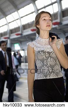 Stock Photo - businesswoman 
holding jacket 
over shoulder. 
fotosearch - search 
stock photos, 
pictures, images, 
and photo clipart