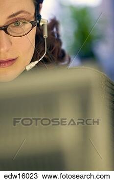 Stock Photo - businesswoman 
using a headset 
while working. 
fotosearch - search 
stock photos, 
pictures, images, 
and photo clipart
