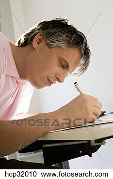 Stock Photography - close up of architect 
drawing at drafting 
table. fotosearch 
- search stock 
photos, pictures, 
images, and photo 
clipart