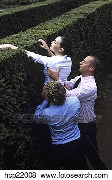 Stock Photo - co-workers lifting 
businesswoman 
over a hedge. 
fotosearch - search 
stock photos, 
pictures, images, 
and photo clipart