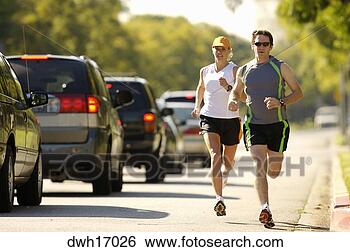 Stock Photo - couple jogging 
against street 
traffic. fotosearch 
- search stock 
photos, pictures, 
images, and photo 
clipart