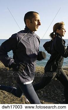Stock Photo - couple jogging 
along shore. fotosearch 
- search stock 
photos, pictures, 
images, and photo 
clipart