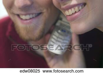 Stock Image - couple listening 
to same cell phone. 
fotosearch - search 
stock photos, 
pictures, images, 
and photo clipart