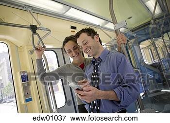 Picture - couple using cell 
phone. fotosearch 
- search stock 
photos, pictures, 
images, and photo 
clipart