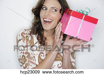Stock Photograph - curious woman 
with gift. fotosearch 
- search stock 
photos, pictures, 
images, and photo 
clipart