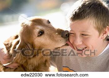 Stock Photography - dog licking boy 
with braces. fotosearch 
- search stock 
photos, pictures, 
images, and photo 
clipart
