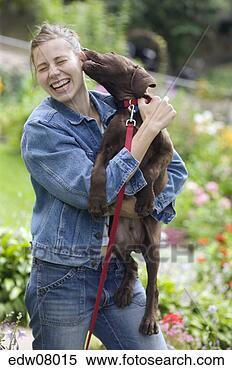 Stock Image - dog licking woman's 
ear. fotosearch 
- search stock 
photos, pictures, 
images, and photo 
clipart