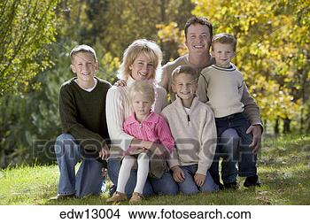 Stock Photo - family sitting 
together outdoors. 
fotosearch - search 
stock photos, 
pictures, images, 
and photo clipart
