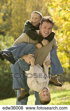 Stock Photo - father and sons 
playing in backyard. 
fotosearch - search 
stock photos, 
pictures, images, 
and photo clipart
