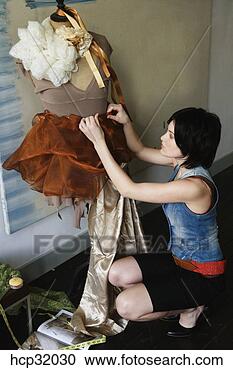 Stock Photography - female clothing 
designer pinning 
fabric on dressmaker's 
dummy. fotosearch 
- search stock 
photos, pictures, 
images, and photo 
clipart
