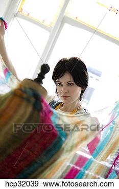 Stock Photograph - female clothing 
designer draping 
fabric around 
dressmaker's dummy. 
fotosearch - search 
stock photos, 
pictures, images, 
and photo clipart