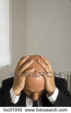 Stock Image - frustrated businessman 
with head in hands. 
fotosearch - search 
stock photos, 
pictures, images, 
and photo clipart