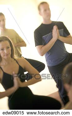 Stock Image - group of people 
practicing yoga, 
tree pose. fotosearch 
- search stock 
photos, pictures, 
images, and photo 
clipart