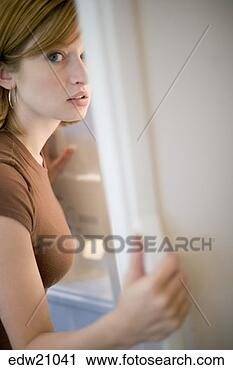 Stock Photography - guilty woman looking 
in refrigerator. 
fotosearch - search 
stock photos, 
pictures, images, 
and photo clipart